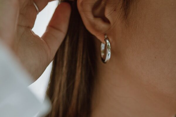 Close up of silver ring ear piercing