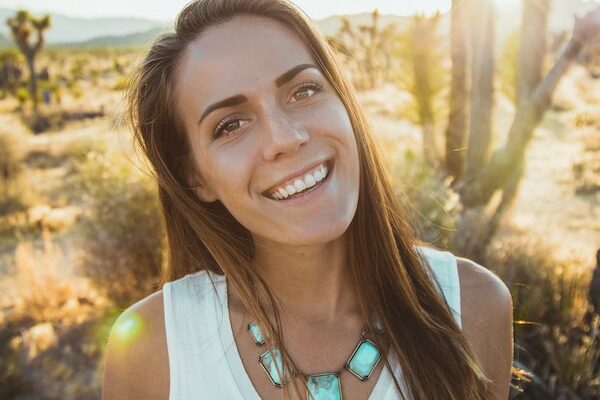 Smiling lady standing in the desert sun