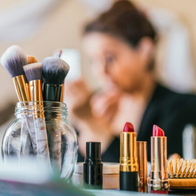 Woman applying makeup at her vanity