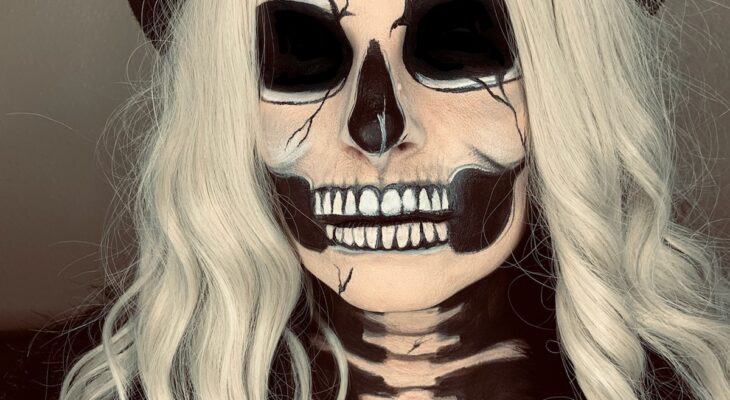 Woman with skull makeup applied to face and chest