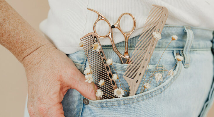 A person with two combs and a pair of shears in their pocket
