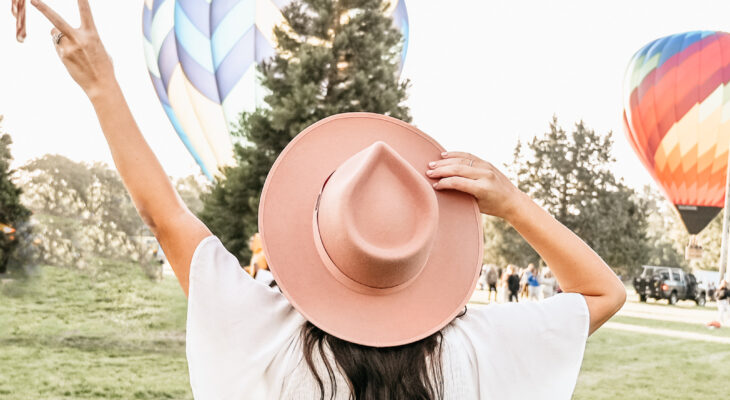 Woman watching hot air balloons go up