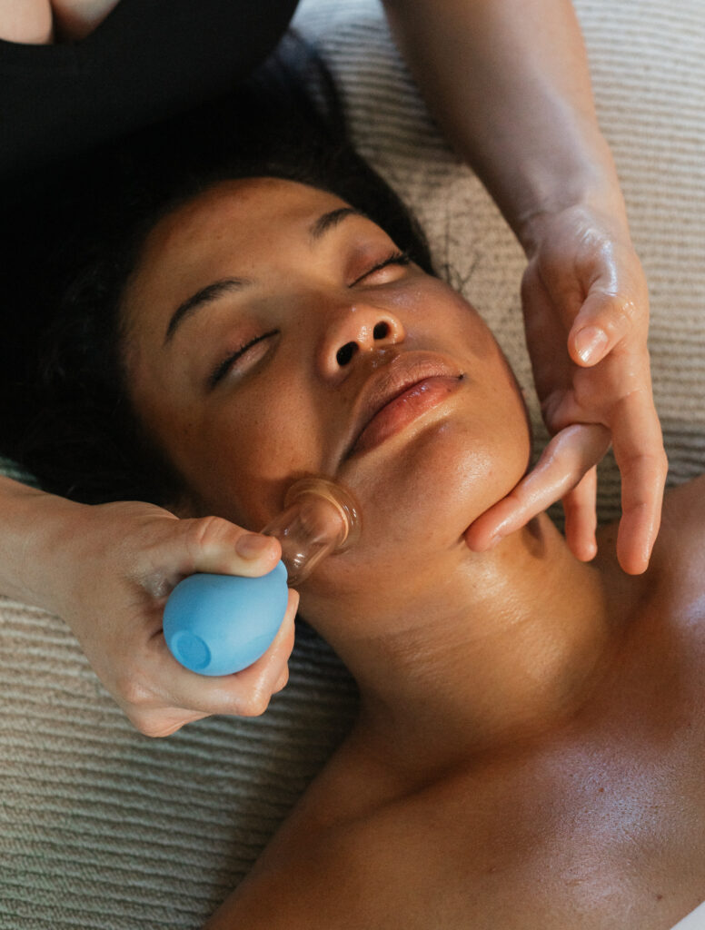 black woman receiving facial cupping treatment